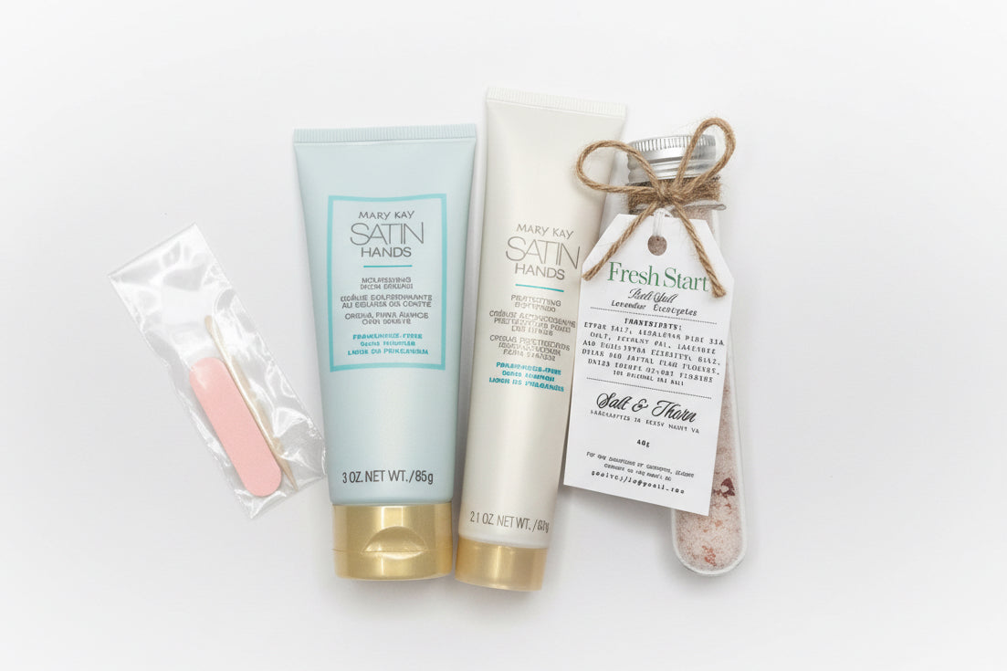 Two bottles of 'Satin Hands' hand cream and a jar of 'Fresh Start' salt and sugar scrub on a white background.