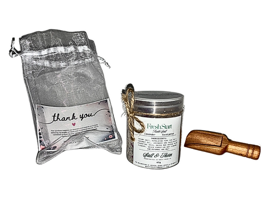 Packaged product with a small container and a wooden tool on a white background