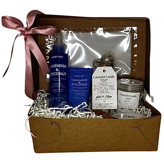 Gift set with skincare products and a candle in a brown box with a pink ribbon.