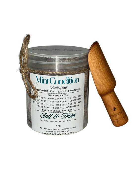 Bath salt container with wooden scoop on a white background