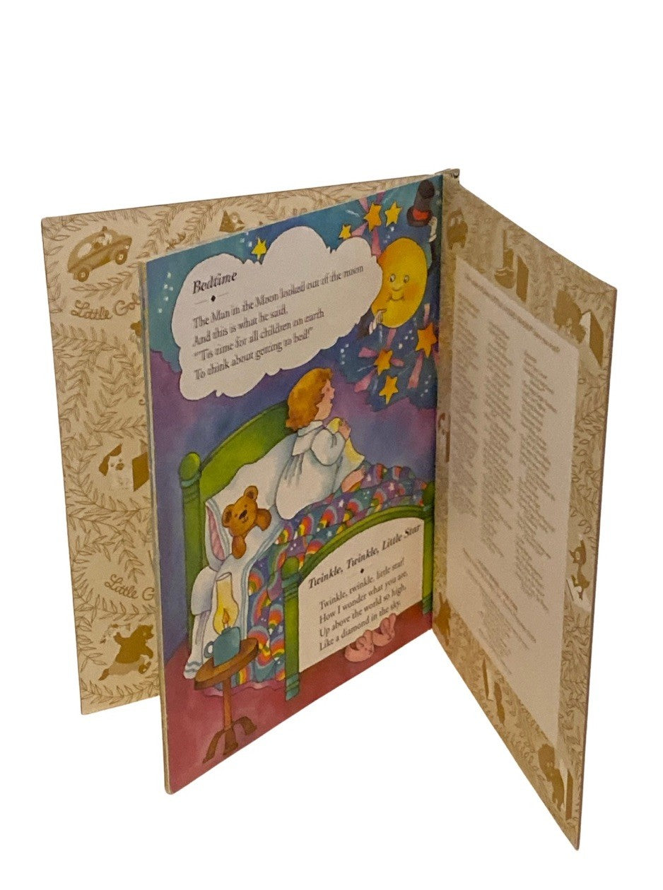 Open book with a colorful illustration of a child in bed with a teddy bear, surrounded by stars and clouds.