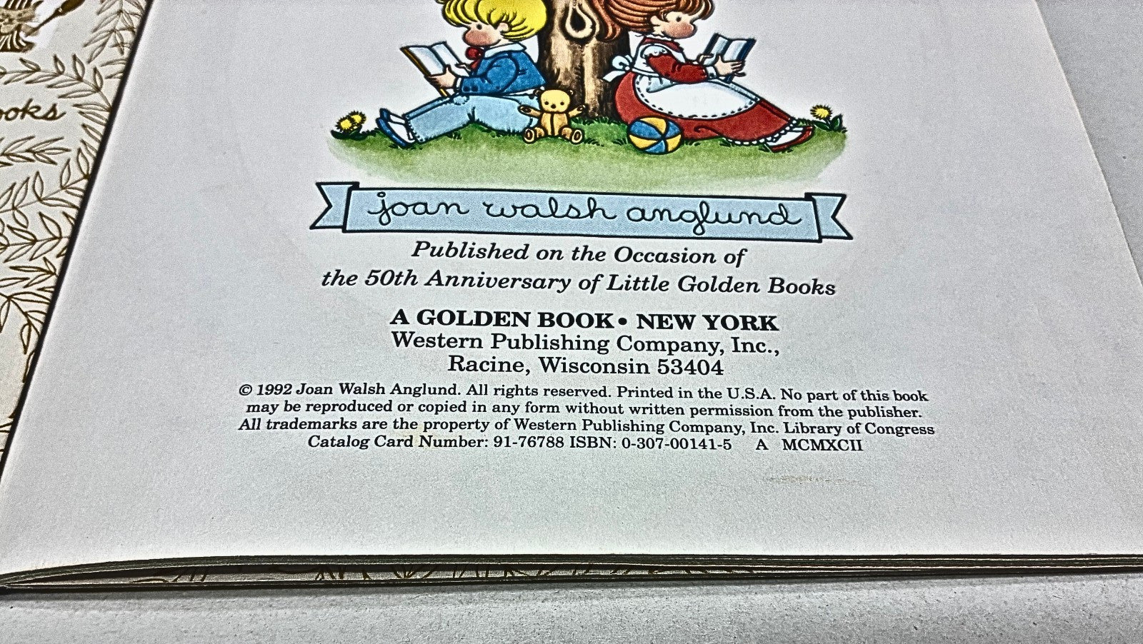 Bookplate with illustration of children reading, text about Joan Walsh Anglund and Little Golden Books, on a gray background.